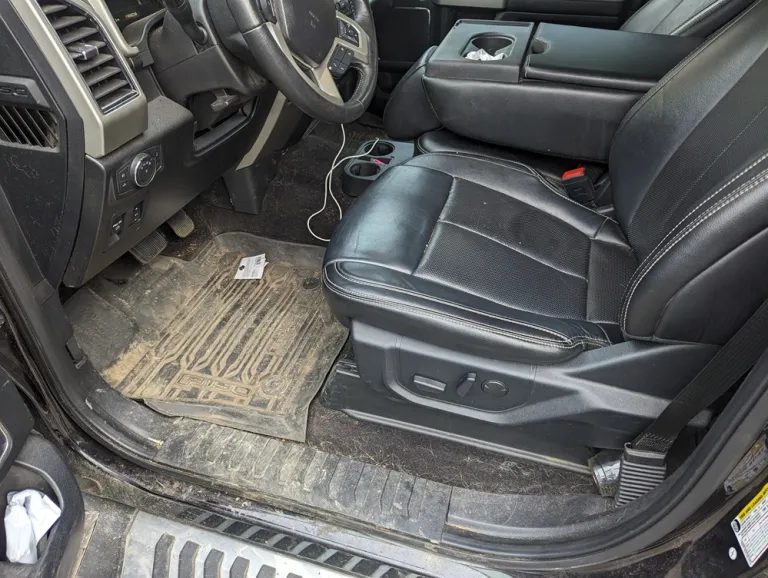 Muddy truck floor mats and interior before detailing